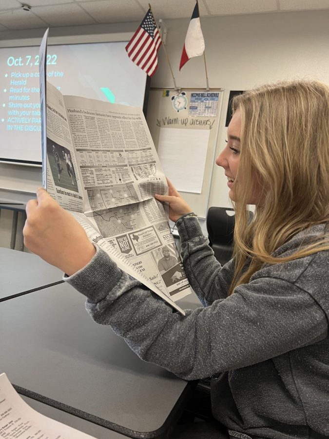 Halle Graybill doing research with the Herald-Zeitung newspaper. We will have a hardcopy newspaper in the spring semester. 