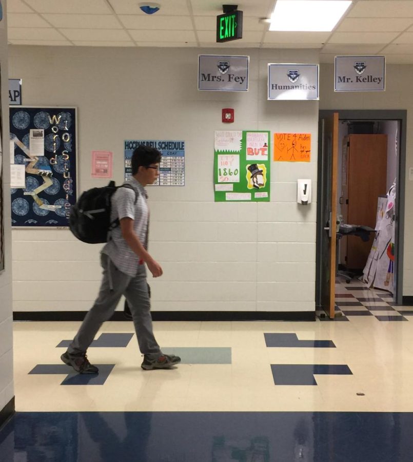 Sophomore student Joseph Wright Lara lugging around a heavy backpack.
