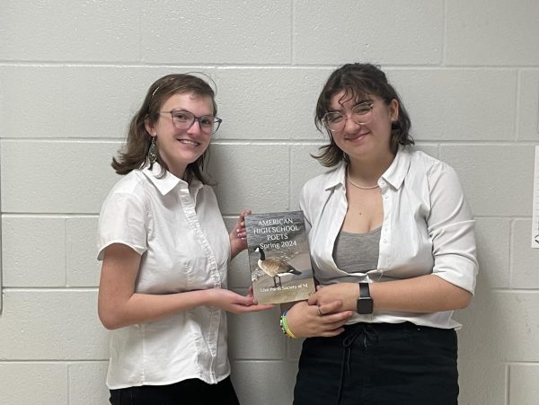 Childers and Hosek pose with the JUST POETRY!!! book with their works inside. 
