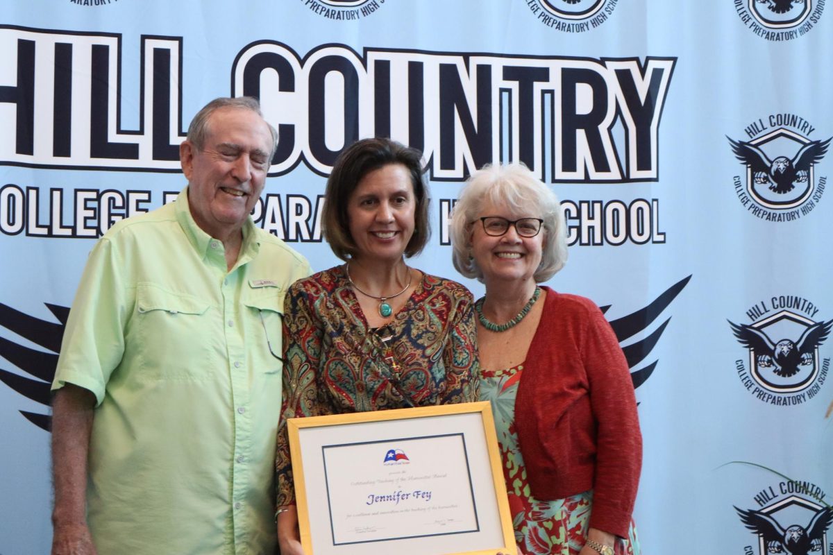 Fey and her parents with her award.