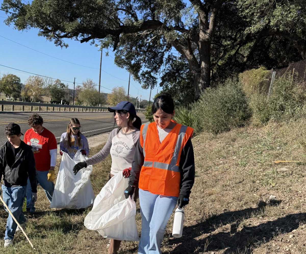 NHS members collect trash along the highway during their ongoing Adopt‑A‑Highway project. Photo Courtesy of Zander Abolos
